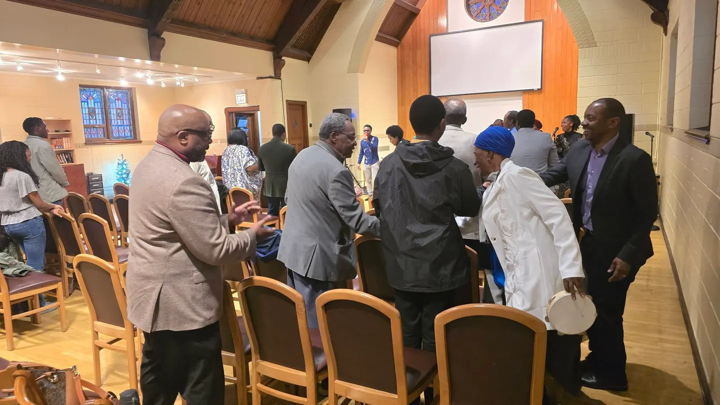 Members talking together in the sanctuary after the service